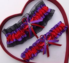 two purple and red garters in a heart shaped box