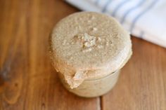 a jar filled with some kind of food on top of a wooden table