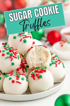 white chocolate covered truffles with sprinkles on a plate next to green and red ornaments