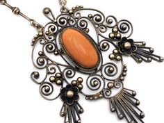 "Amazing late Victorian coral cameo and gilded silver filigree necklace. Very elaborate hand-wrought design featuring a two layered pendant that lends a charming movement to the piece. The focal point is the high relief coral cameo of a classical goddess. The lower panel features a matching coral cabochon. The swirling filigree is studded with tiny gilded silver beads. Delicate milgraining throughout adds a subtle texture. The chain is very simple and the clasp is original and works perfectly. I Victorian Filigree Pendant Necklace, Victorian Bronze Filigree Necklace, Victorian Oval Cameo Pendant Necklace, Ornate Antique Gold Cameo Necklace, Ornate Cameo Necklace Collectible, Dark Mori, Filigree Necklaces, Squash Blossom Necklace, High Relief