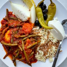 a white plate topped with rice and vegetables