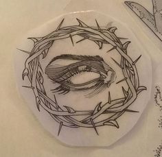 a sticker with a drawing of a woman's eye in a crown of barbed wire