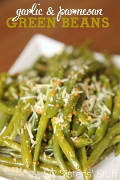 green beans with garlic and parmesan cheese on top in a white plate, ready to be eaten