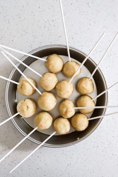 several skewers of food in a pan with toothpicks sticking out of them