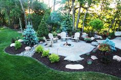 a fire pit surrounded by chairs and trees