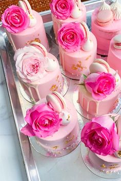 there are many pink cakes with flowers on them