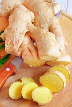 ginger root and sliced up lemons on a cutting board