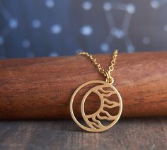 A beautiful, matte gold plated celestial necklace featuring a crescent moon and sun. Adjustable to fit most necklines it looks great with everything - you'll never want to take this one off! Also the perfect gift for anyone who appreciates earth magic and loves all things celestial and witchy DETAILS: NECKLACE: * Pendent is just under 3/4 in (1.8 cm) wide * Adjustable matte 24 gold plated brass chain is 16 inches adjustable up to 18 inches PACKAGING: * Necklace will arrive on card backing in a c Celestial Brass Necklace With Moon Charm, Celestial Brass Necklace With Moon Phase Detail, Celestial Brass Necklace With Moon Phase, Celestial Brass Moon Phase Necklaces, Celestial Moon Phase Brass Necklace, Celestial Brass Moon Phase Necklace, Celestial Brass Necklace With Adjustable Chain, Moon Phase Brass Pendant Necklace, Celestial Crescent Brass Necklace