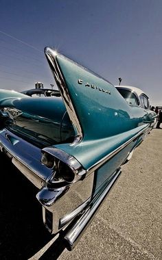 an old car parked in a parking lot