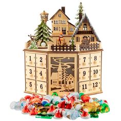 a wooden clock with candy in front of it and christmas decorations on the bottom floor