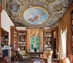 a living room filled with furniture and a painting on the ceiling