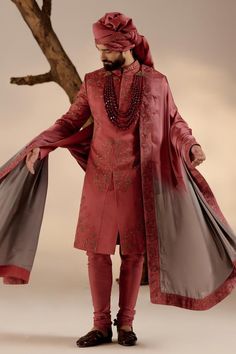 Red full sleeves sherwani in linen silk base with all over tone on tone resham work, gold zari and dabka details. Paired with full sleeves plain kurta, churidar and safa. Components: 4 Pattern: Embroidery Type Of Work: Resham, Zari, Dabka Neckline: Band Sleeve Type: Long Fabric: Linen Silk Color: Red Other Details:  Closure:  Sherwani: Front hooks Kurta: Front placket buttons Note: The jewellery and stole worn by the model is not for sale Occasion: Groom - Aza Fashions Jatin Malik, Embroidered Sherwani, Blouse Yoke, Resham Work, Red Ochre, Dhoti Pants, Royal Look, Indian Man, Indian Wedding Outfits