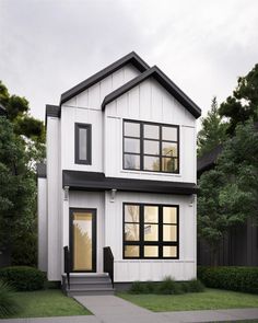 a white two story house with black trim on the front door and stairs leading up to it