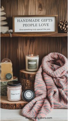 A photo of a cozy setup with handmade items such as knitted scarves, candles, and sugar scrub jars. There's a knitted scarf with a pink and blue pattern. There's a candle with a green label. There's a sugar scrub jar with a label that says "Sugar Scrub". The background is a wooden shelf. There's a wooden sign above the shelf that says "Handmade Gifts People Love". Subtext below the sign says "Give something truly special this year.". Diy Hot Chocolate, Sugar Scrub Homemade, Personal Calendar, Always Thinking Of You, Custom Calendar, Diy Calendar, Customised Mugs, Easy Diy Gifts