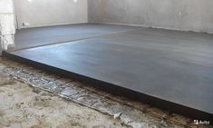 an unfinished room with concrete floors and cement flooring on the ground in front of it