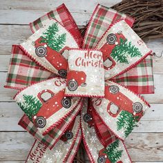 a red and green christmas bow with the words merry christmas on it's side