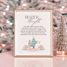 a pink christmas tree next to a framed sign that says, diaper through the night