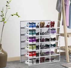 a rack that has many pairs of shoes on it next to a vase and ladder