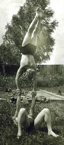 a man doing a handstand in the yard