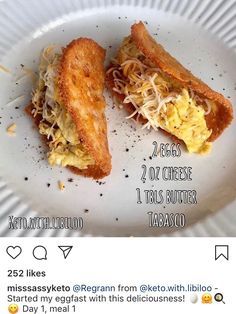 a white plate topped with two pieces of toasted bread covered in egg and cheese