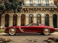 a red car parked in front of a large building