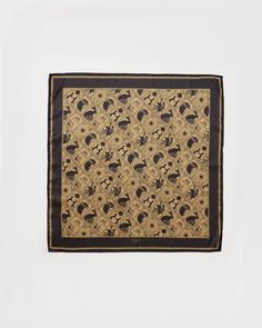 a black and brown square scarf with skulls on it's sides, in front of a white background