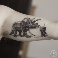 the arm is decorated with an origami style bull and elephant on it's left side