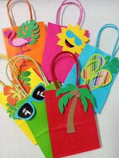 colorful paper bags with palm trees, sunglasses and sunflowers on them are sitting on a white surface