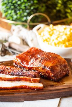 ribs, corn and barbecue sauce on a cutting board