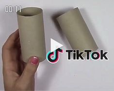 a person holding two rolls of toilet paper in their hand with the words tiktok on it