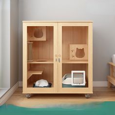 a wooden cabinet with two glass doors on the front and one door open to let cats in