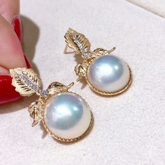 Highlight: The Best Quality Mabe Pearl Product Information OriginMabe Pearl Jewelry Processed in Japan MaterialMabe Pearl, 18k Gold, and Diamond DimensionsEarrings Length 3.0 cm Pearl Shaped: Round Size: 14-15 mm Quality: AAAA Nacre: Very Thick Color: White Luster: Very High Accessories Metal: 4.92 g of 18k Gold Other: 0.18 ct of SI Quality Natural Diamond Luxury Pear-shaped High Luster Pearl Earrings, Luxury High Luster Pear-shaped Pearl Earrings, Exquisite Yellow Gold Pearl Earrings, Luxury Round Earrings With High Luster, Luxury High Luster Round Earrings, Luxury High Luster Pearl Earrings For Gift, Luxury High Luster Round Pearl Earrings, Mabe Pearl Jewelry, Conch Pearl