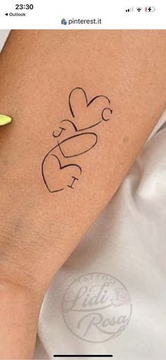 a woman's arm with a tattoo on it that says love and is next to a banana