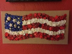 an american flag made out of buttons is hanging on the wall next to a framed picture