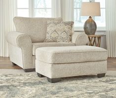 a living room scene with focus on the chair and ottoman