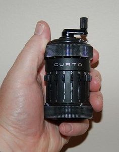 a person holding a camera lens in their hand