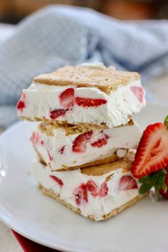 three strawberry shortcakes stacked on top of each other with strawberries next to them