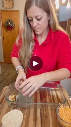 a woman standing in front of a counter making macaroni and cheese