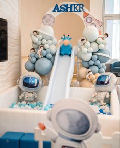 an astronaut themed birthday party with balloons and decorations