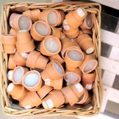 a basket filled with lots of brown cups