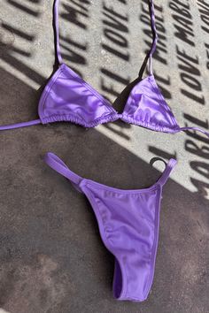 Introducing our stunning Unicorn lavendar 2 Piece T String Bikini! This eye-catching swimsuit is beautifull in the sunlight. The bikini top features a flattering halter neckline and adjustable straps for a comfortable and secure fit. The matching bottom offers moderate coverage with a scrunch bottom. Perfect for the fashion-forward beach-goer, this Unicorn 2 Piece Bikini is sure to turn heads and make a statement. Get ready to shine this summer with this must-have swimsuit! This Unicorn Lavender Lavender Triangle Top Swimwear For Summer, Purple Halter Neck Swimwear For Summer, Summer Halter Neck Purple Swimwear, Summer Lavender Swimwear For Swimming, Purple Beachwear Swimwear With Adjustable Straps, Purple Adjustable Straps Swimwear For Beach, Summer Lavender Swimwear For The Beach, Purple Adjustable Straps Beachwear Swimwear, Lavender Summer Swimwear For The Beach