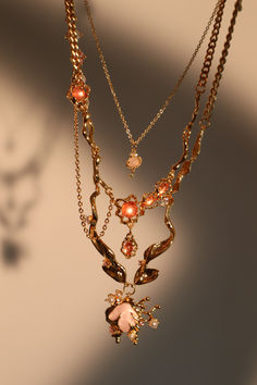 Flicker goodbye to dullness and stand out in our 18K Real Gold Plated Pink Shell Necklace. With the proper lighting, the zirconia pink gemstones add a pop of shine to your ensemble. This unique necklace is layered with our Pink Gem Dangle Necklace and Pink Gem Saturn Necklace, making your outfit stand out and is also a great gift for her or him... Pink Cubic Zirconia Clavicle Necklace, Elegant Pink Necklace With Jewels, Elegant Pink Jeweled Necklaces, Glamorous Jeweled Necklaces For Gifts, Pink Pendant Necklace With Jewels, Pink Jewel Pendant Jewelry, Pink Jeweled Pendant Jewelry, Luxury Pink Necklace For Gift, Pink Cubic Zirconia Pendant Necklace