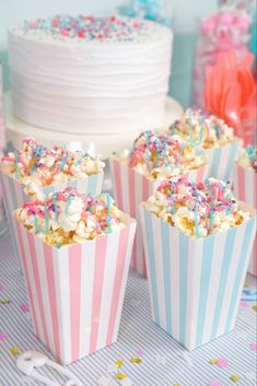 some cupcakes with sprinkles are on a table