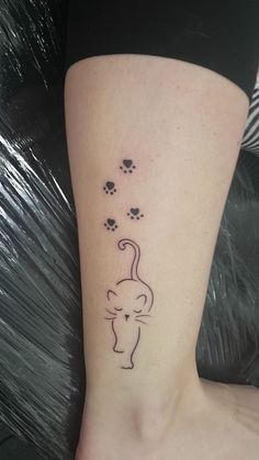 a small cat tattoo on the ankle