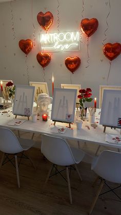 the table is decorated with hearts and candles