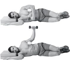 the man is doing exercises with dumbbells on his chest and back while lying down