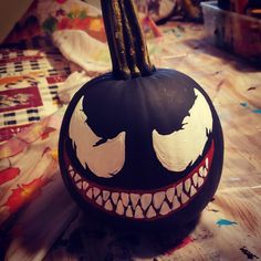 a painted pumpkin sitting on top of a table