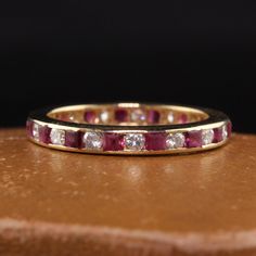 Beautiful Vintage Retro 14K Yellow Gold Diamond and Ruby Eternity Band. This beautiful band is crafted in 14k yellow gold. The band has diamonds and natural rubies alternating around the entire ring. The rubies of the ring are abraded due to normal wear. Item #R1362 Metal: 14K Yellow Gold Weight: 2.4 Grams Size: 6 Diamond: Approximately .50 cts Color: H Clarity: VS2 Ruby: Approximately .50 cts Measurements: Top of the ring measures 2.75 mm wide and band measures 2.75 mm wide. Measurements off th Ruby Eternity Band, Watch Cufflinks, Heart Band, Red Band, Eternity Band, Natural Ruby, Watch Necklace, Eternity Bands, Gold Style