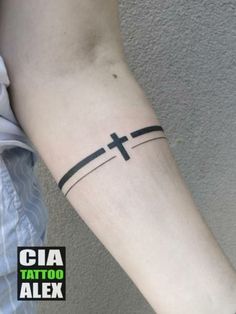 a person with a cross tattoo on their arm and the words cia tattoo alex written in black ink