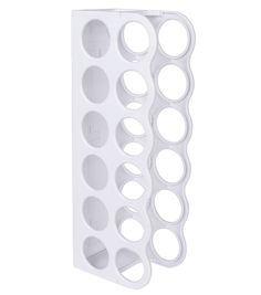 a white wall mounted bottle holder with circles on the front and bottom, in an angled position